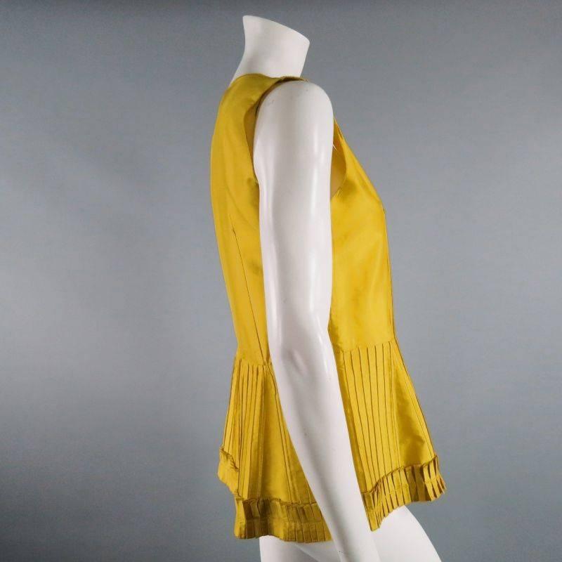 Sleeveless, versatile spring/summer top by OSCAR DE LA RENTA.  Dress up or dress down for work, play or special occasion.  Square neck with gathering at shoulders.  A- line cut with flare starting at waist.  Vertical pleating throughout with pleated