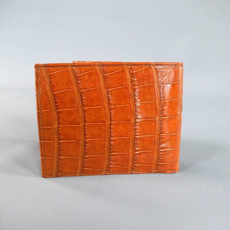 Brand New MOORE & GILES Wallet consists of Alligator Leather material in a tan color tone. Designed in a sleek and slim smaller shape wallet. Includes six card pockets and two slip pockets for paper currency. Hand burnished with wax to impart a rich
