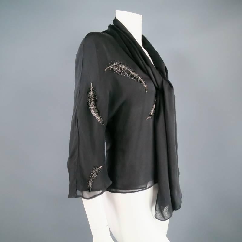 Gorgeous silk dress top by VALENTINO. In a flowy sheer fabric, this effortless piece features a V neckline with sash attached, a 3/4 ruffle sleeve, and sparkling beaded feathers in black and silver.Made in Italy.
 
Excellent Pre-Owned Condition.
