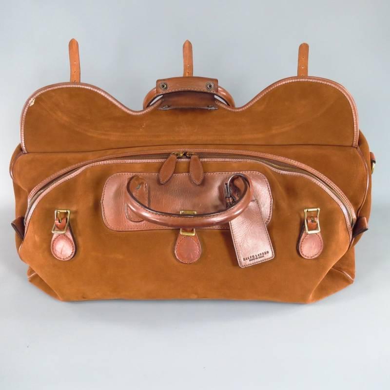 Large travel bag by RALPH LAUREN. This classic style comes in a luscious tan suede and features a frontal flap with triple dark gold tone buckle closure, top handles with snap, embossed leather patches, frontal zip opening, and detachable shoulder
