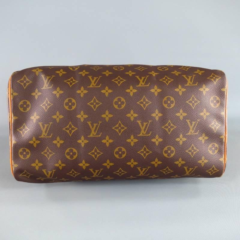 This VINTAGE Speedy 35 by LOUIS VUITTON comes in classic brown and tan monogram print canvas and features double top handles in vachetta patina leather, leather piping, top gold tone zip closure and internal pocket. Made in USA.
 
Very Good