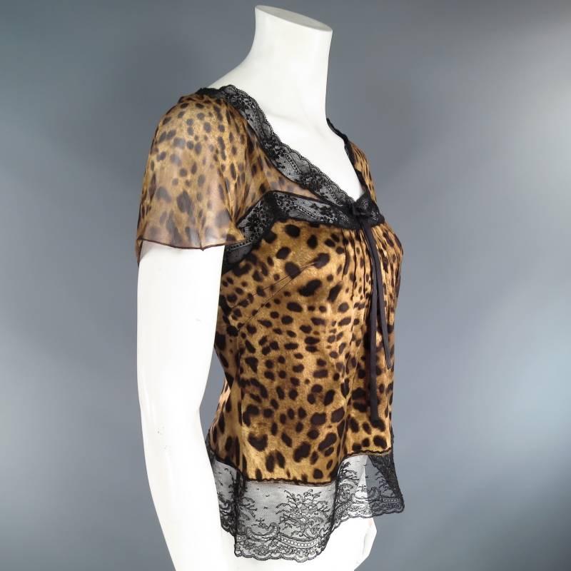 This sexy and luxurious camisole top by DOLCE & GABBANA comes in a gorgeous high quality leopard print silk blend and features a dart pleated V bust line with black lace trim and bow that connects to a leopard chiffon ruffled capelet that overlays