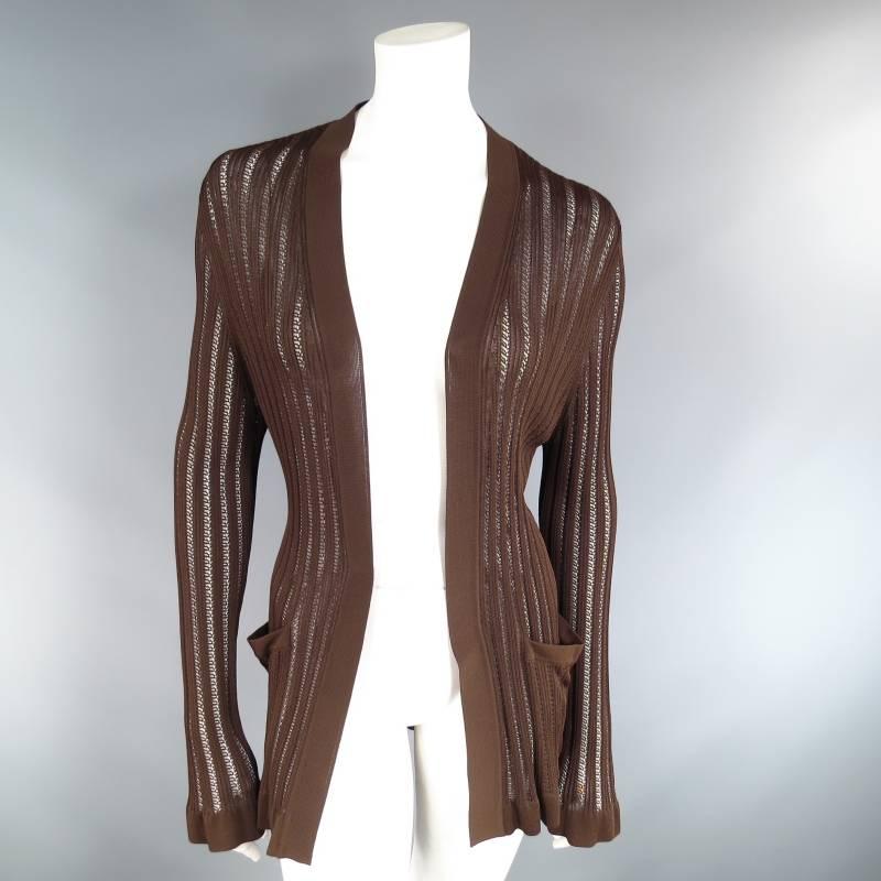 This fabulous long sleeve, open front cardigan by HERMES comes in a light weight rich brown viscose knit in a ribbed see though mesh and features ruffled hems, and double side pockets. This piece comes in great vintage condition with a couple small