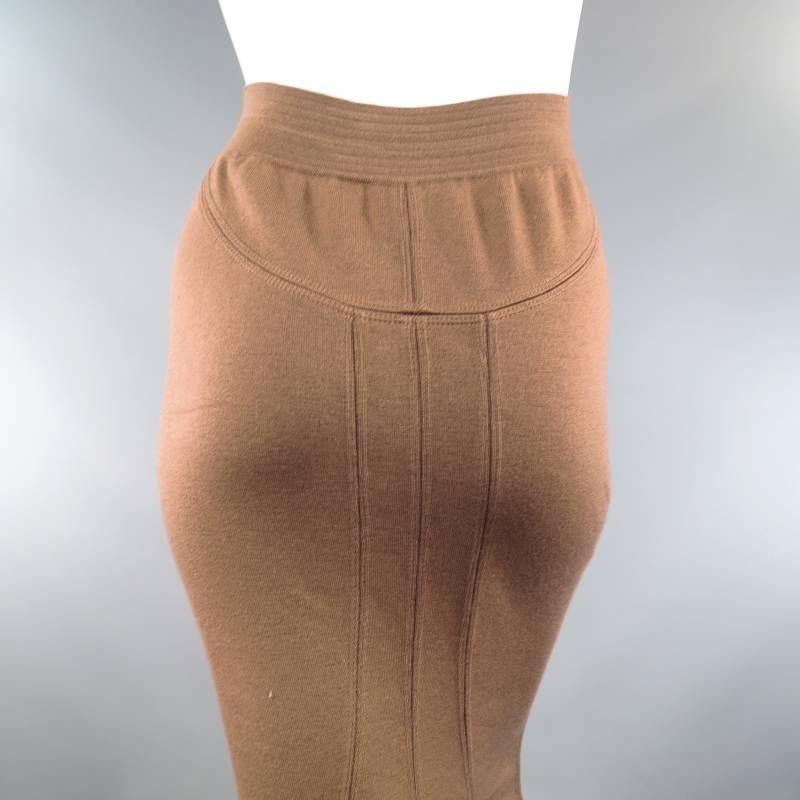 This vintage midi pencil skirt from ALAIA comes in a gorgeous light tan taupe brown wool blend stretch knit and features a thick ribbed waistband, slinky bodycon fitted silhouette, and panel constructed back with fishtail hem. This vintage piece