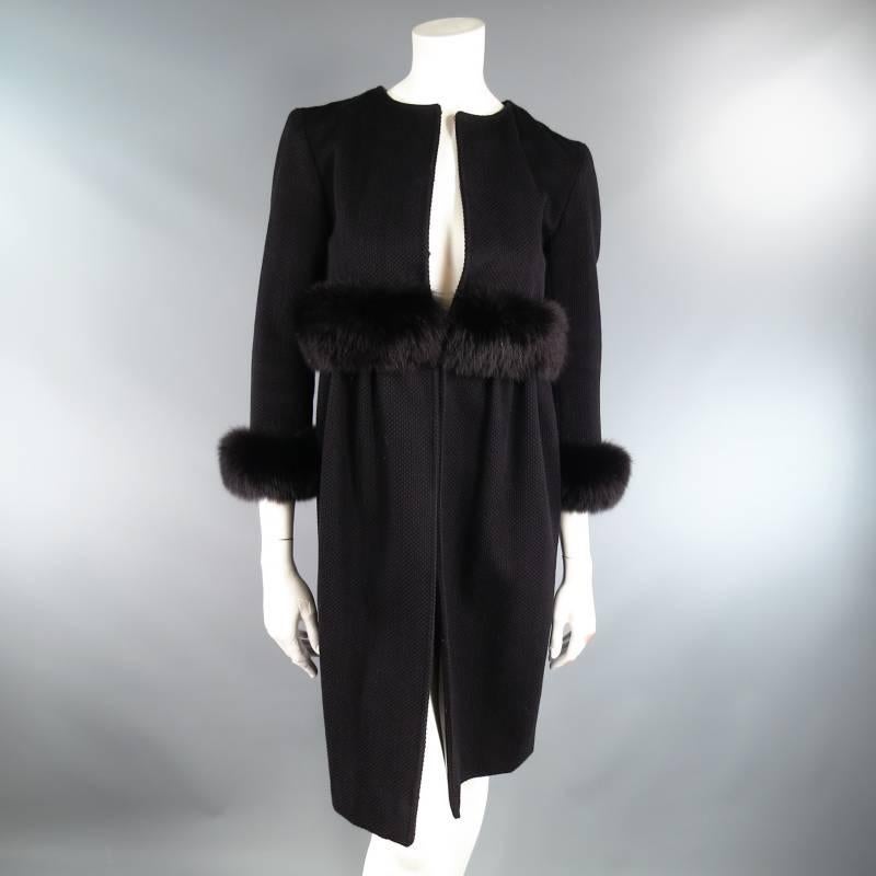 This fabulous JEFFREY CHOW coat comes in a textured black fabric and features a crew neckline, three quarter sleeve, empire waist with black fur trim, hook eye closure, and gathered top skirt. A unique piece for various occasions.
 
Very Good
