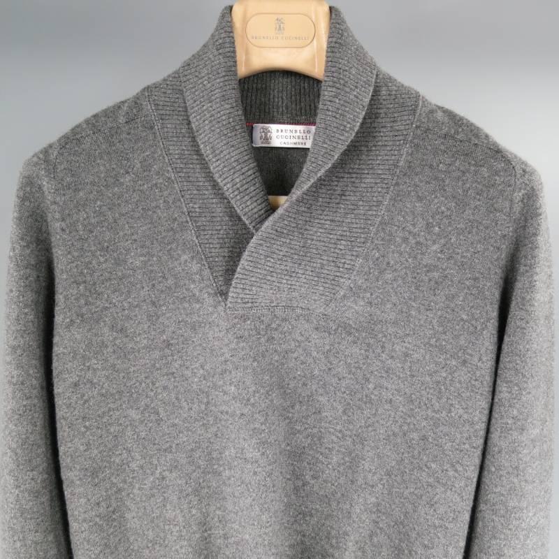 Brunello Cucinelli Sweater consists 100% cashmere material in a grey color tone. Designed with a shawl collar in a ribbed texture, tone-on-tone stitching throughout body with a raglan detailing along shoulders. Ribbed cuffs with blousen hem.
Made