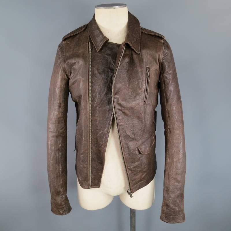 This unique biker style jacket by RICK OWENS comes in a rich brown wrinkle textured structured leather and features a pointed collar, epaulets, diagonal zip closure, internal snap closure option, zip breast pocket, zip slit pockets, mini flap