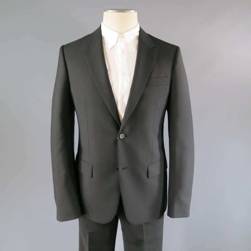Brand New Alexander McQueen Suit consists of wool/mohair blend material in a black color tone. Designed with a notch lapel collar, 2-button front, tone-on-tone stitching seen towards mid-section. Detailed with a top inseam pocket square, 2-bottom