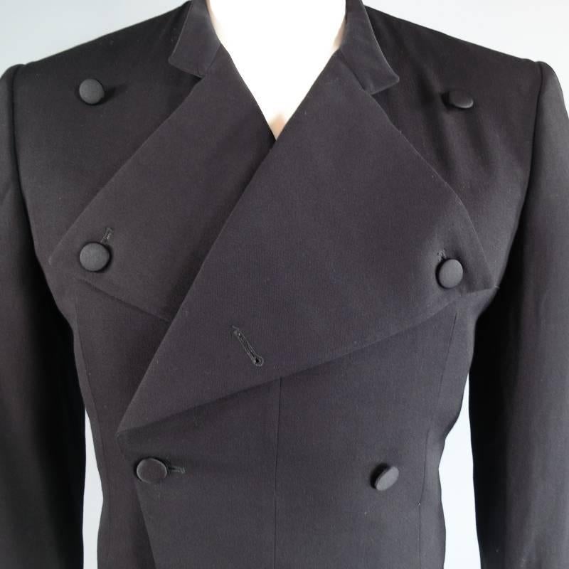 Brand New with Tags Yves Saint Laurent rive gauche Jacket consists of 100% wool material in a black color tone. Designed in a cropped style, wide notch lapel collar with a double breasted button front in silk.  Detailed with 4-button cuffs on each