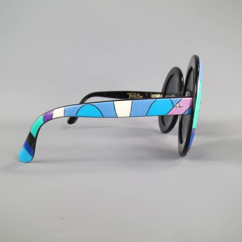 These fabulous vintage 1970's EMILIO PUCCI sunglasses come in a signature teal, blue, and purple Pucci print acetate with a black base and feature oversized round lenses. Made in France.
 
Good Pre-Owned Vintage Condition.
 
Measurements:
