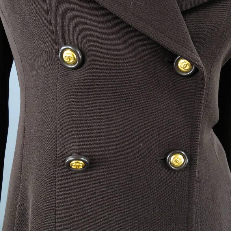 Fabulous double breasted jacket by CHANEL. A vintage style for the modern fashionista, this piece comes in a rich brown wool twill and features a unique long peak lapel, slit pockets, functional button sleeve with cuff and gold tone 