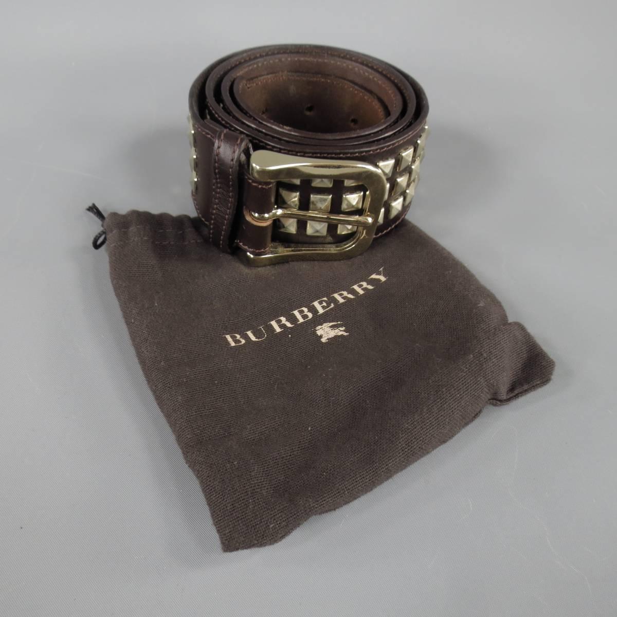 BURBERRY belt is Italian leather and features chrome shine golden hardware, 3-row pyramid studs in deep brown mahogany, made in Italy.
 
Excellent Pre-Owned Condition    Marked: 36
 
Measurements:
 
Length: 40
Width: 2 in.

Item ID: 74172
