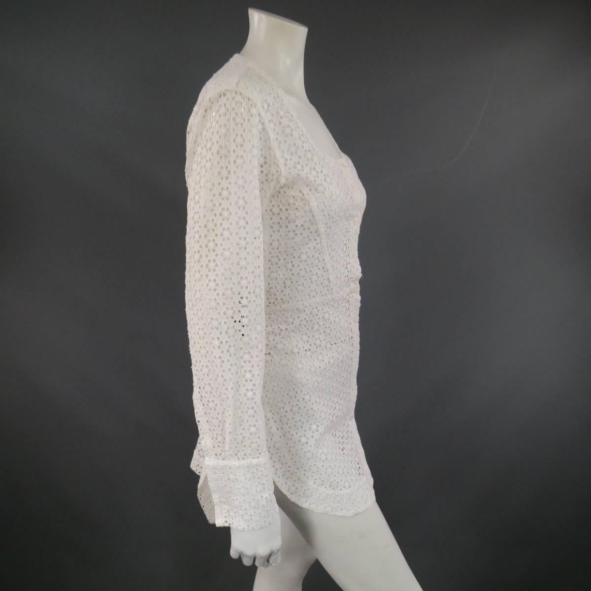 This gorgeous ALAIA blouse dress comes in white cotton lace with all over flower polka dot cutout print and features a scoop neck, long sleeves, curved hem and gather back slit skirt. Buttons on cuffs have been moved on one side. Made in Italy.
