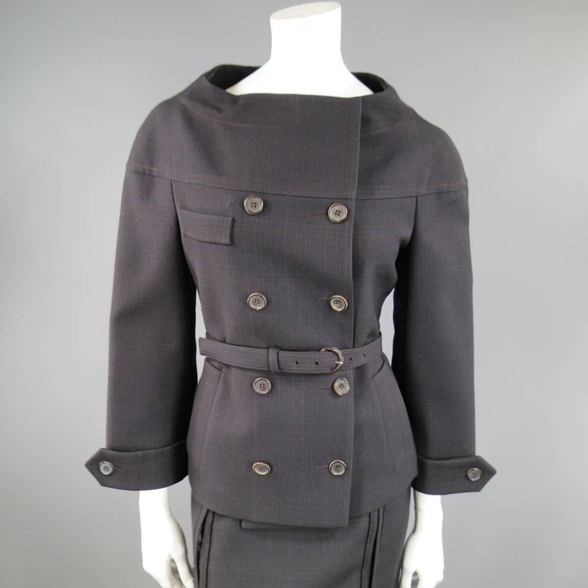 This fabulous 1960's inspired PRADA suit includes a jacket in a dark brown and navy blue plaid wool and features a button up double breasted closure, double side pockets , belted waist, sleeve epaulets, and high curved neckline with a matching raw