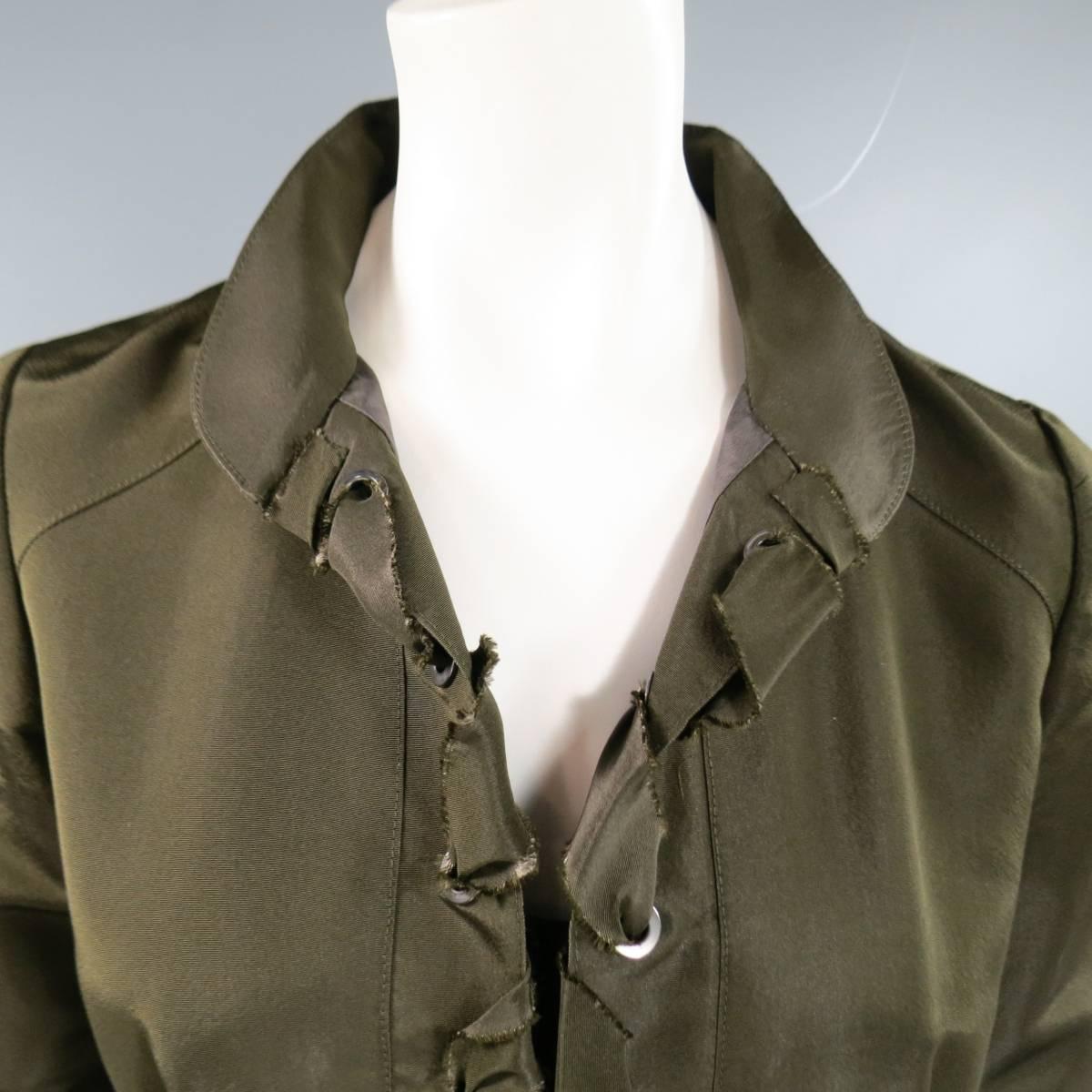 This stunning OSCAR DE LA RENTE cocktail dress comes in olive khaki green silk taffeta and features a 3/4 sleeve, rounded collar, cinched waist with double faux flap pockets, pleated bubble A line skirt, and double placket front with silver tone