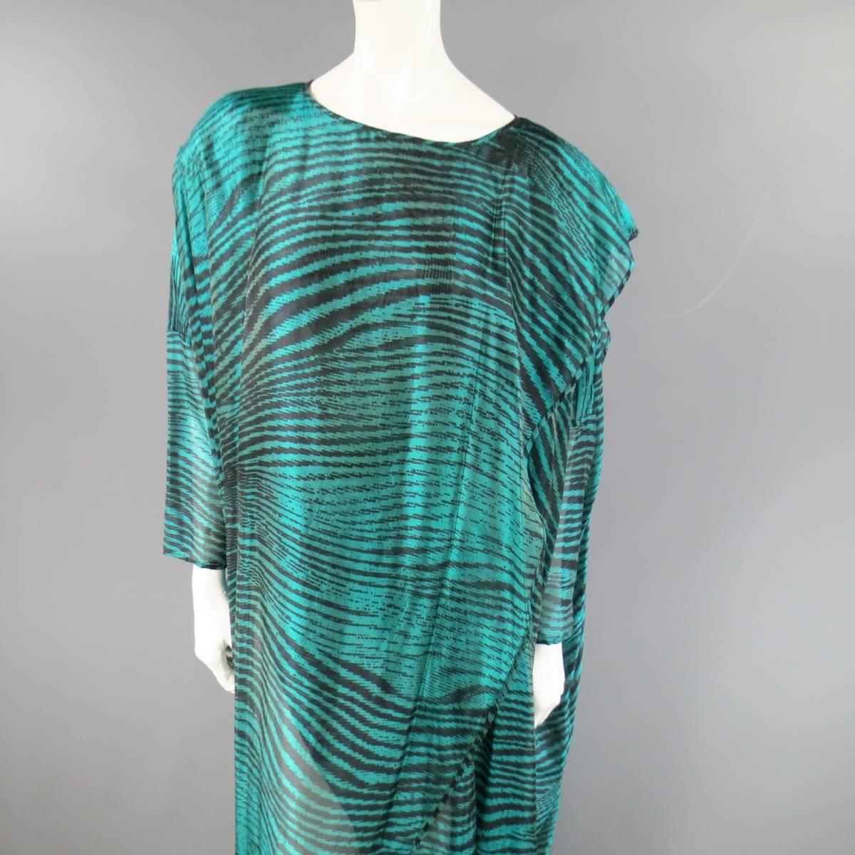 This fabulous vintage MISSONI for Bullock's caftan dress comes in a semi sheer teal green and black abstract zebra stripe print silk blend fabric and features a high scoop neck, 3/4 sleeves, and draped wrap overlay construction. Made in Italy.
