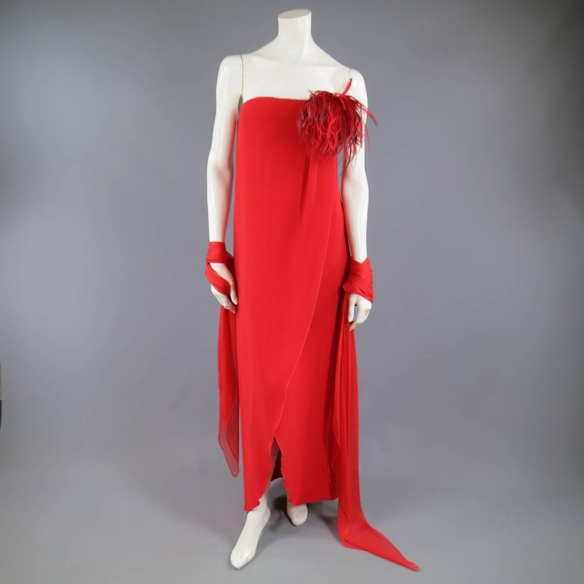 This stunning VALENTINO evening dress comes in a brilliant red silk crepe and features a straight, strapless neckline with voluminous feather applique, wrap slit front, built in bustier, and includes a matching chiffon evening scarf. Made in