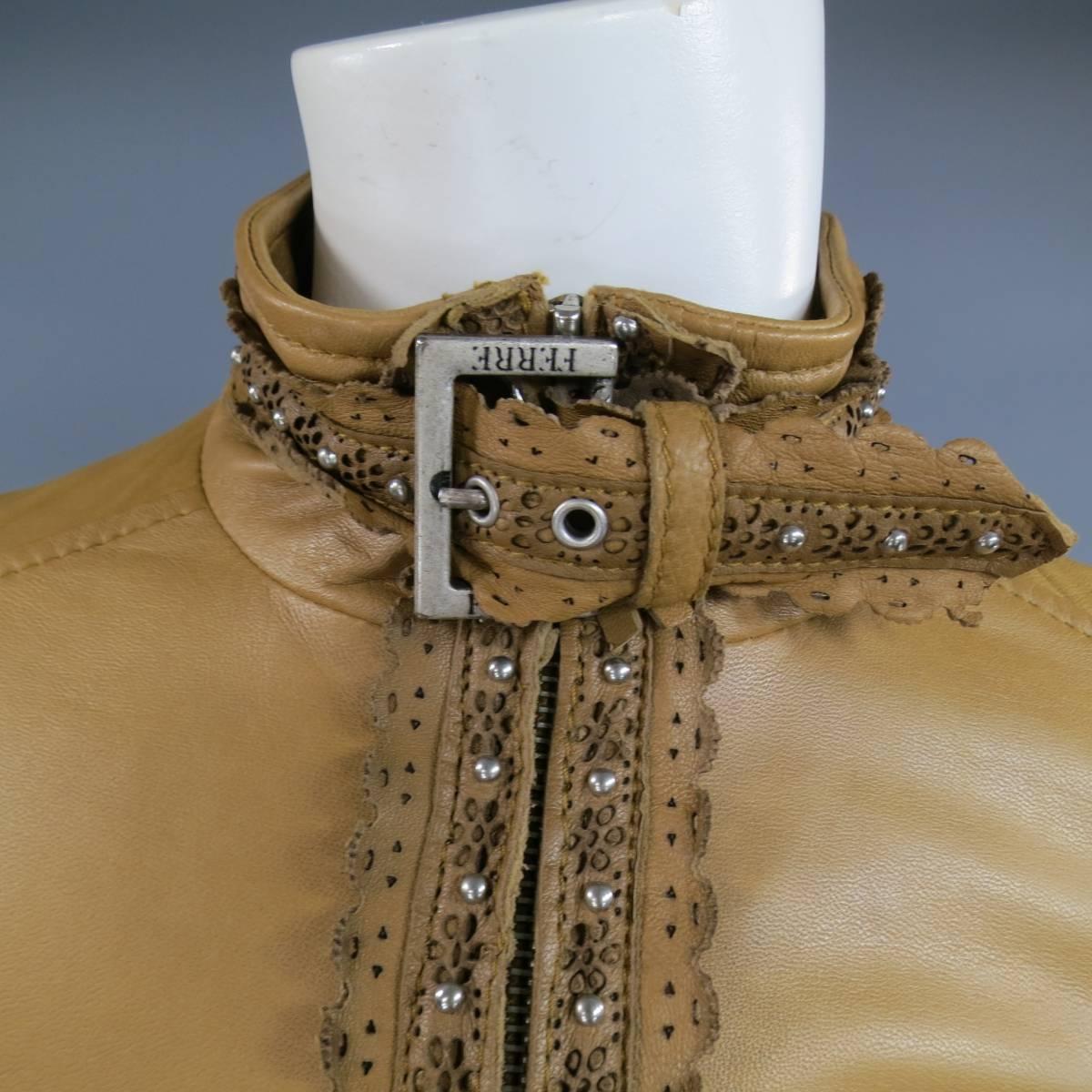 This lovely vintage GIANFRANCO FERRE cropped moto jacket comes in a tan caramel beige smooth leather and features a stand up buckle neck, zip closure, double zip pockets and leather cutout lace trim throughout with silver tone studs detail. Spot on