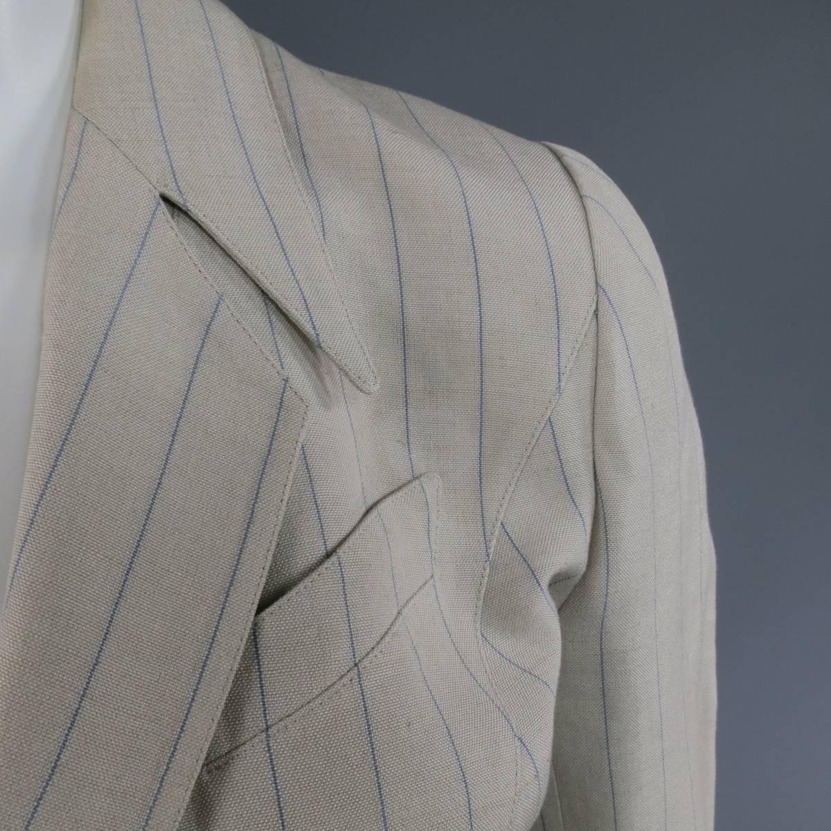 This gorgeous THIERRY MUGLER vintage jacket comes in a beige and blue pinstriped linen poly blend and features a double breasted snap closure, signature downward pointed peak lapel, slanted flap pockets and impeccable hourglass tailoring with a