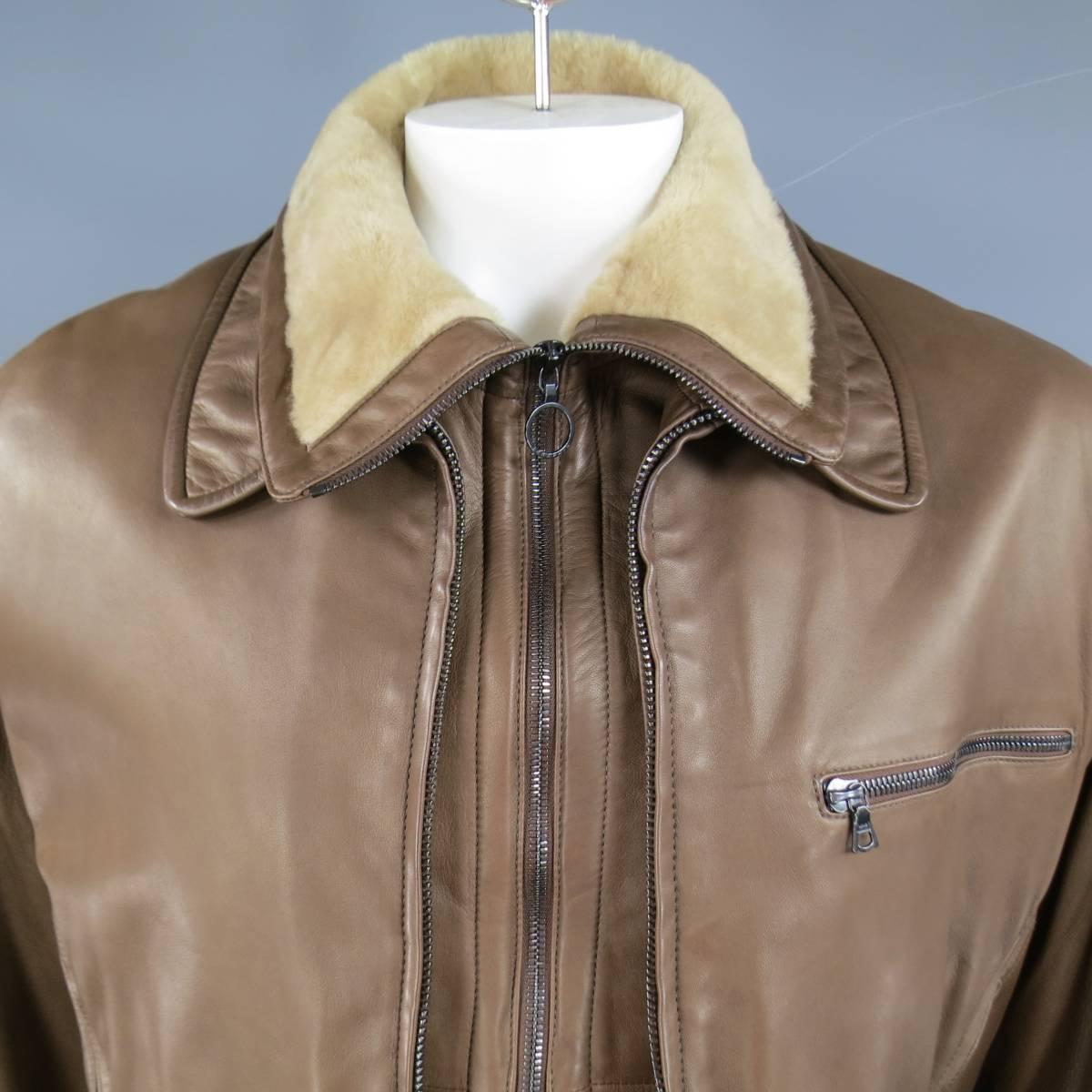 This unique bomber jacket by SERAPHIN comes in a soft light brown lamb leather and features a detachable shearling collar frontal layer, oversized silhouette, triple gunmetal zip pockets, and ribbed bands. Made in France.
 
Excellent Pre-Owned
