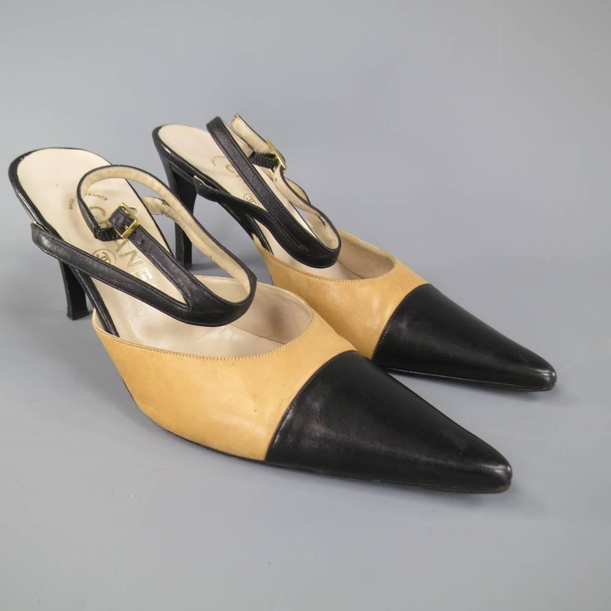 Iconic CHANEL pumps in black smooth leather featuring a pointed cap toe with tan beige body, covered skinny heel, and double ankle strap harness. Made in France.
 
Good Pre-Owned Condition.
Marked: IT 37.5
 
Heel: 3.5 in.
