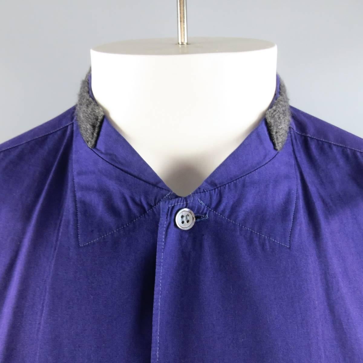 Comme des Garcons Long Sleeve Shirt consists of 100% cotton material in a purple color tone. Designed in a Nehru collar that comes in a wool trim, tone-on-tone stitching and patch pocket. Oversize fit. Discolorations throughout. As-Is. Made in