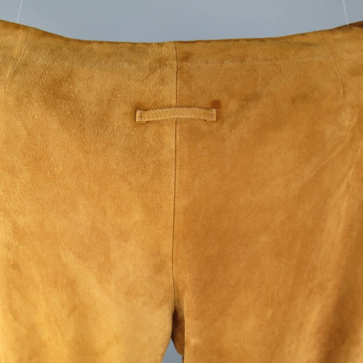 Vintage JEAN PAUL GAULTIER pants in a rich tan soft suede with a clean, semi flair silhouette and signature back tab. Imperfection on back. Never worn.  Made in Italy.
 
New with Defect and Tags.
Marked: US 34
 
Measurements:
 
Waist: 38 in.
Rise: