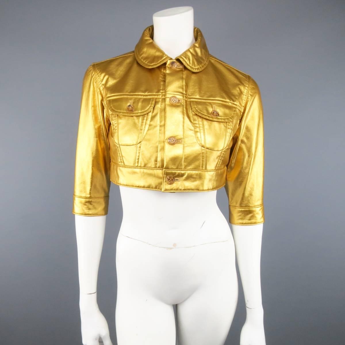COMME DES GARCONS cropped trucker style jacket in a metallic yellow gold faux  leather featuring patch flap breast pockets, tortoise shell buttons, three-quarter sleeves, and round peter pan collar. Tag ripped. As-Is. Circa 2007. Made in Japan.

