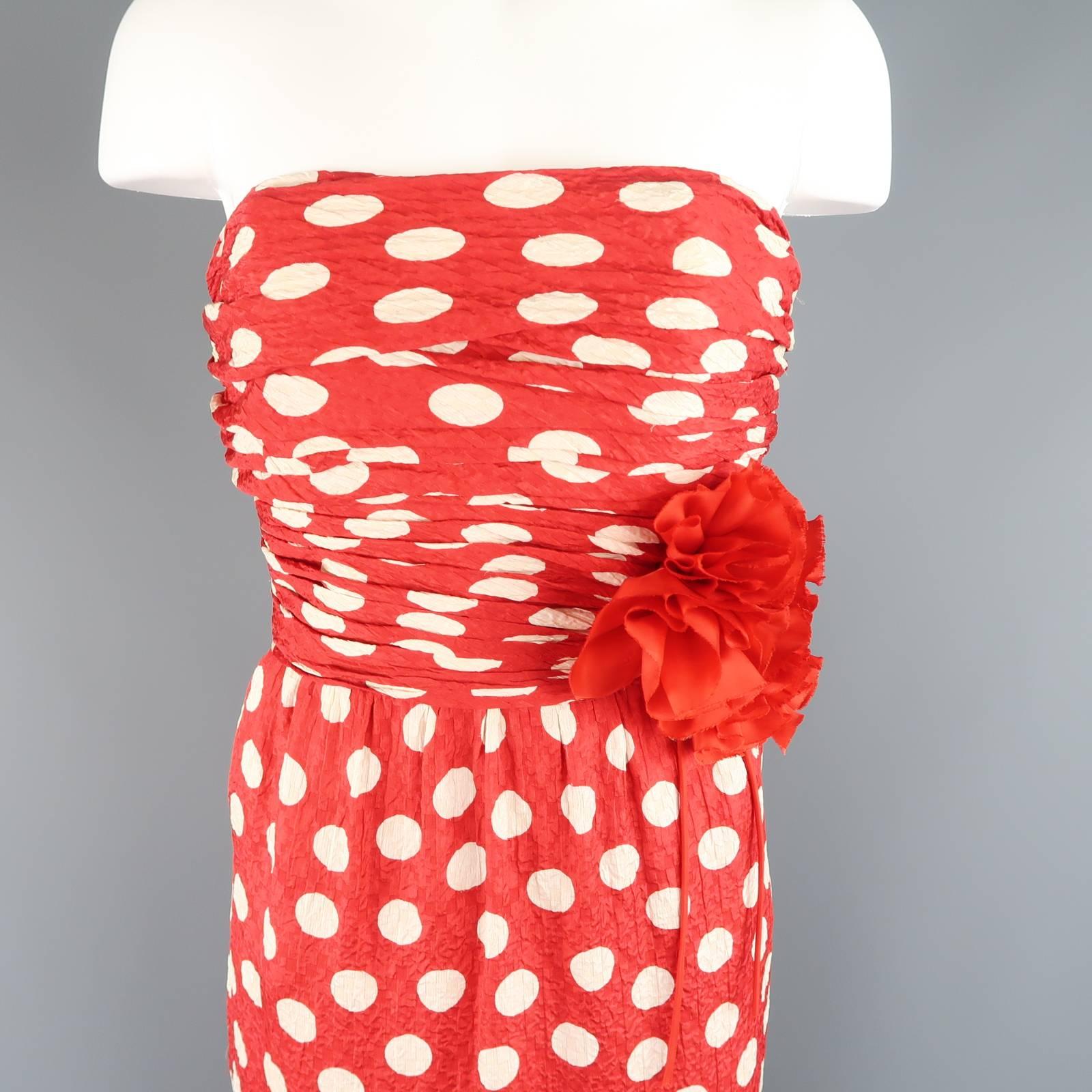 This gorgeous vintage 1980's CHANEL gown comes in a red and white polka dot textured silk and features a ruched bodice, floral embellished waist, and gathered beck hem. Wear throughout. As-Is. Made in France.
 
Good Pre-Owned Condition.
Marked: 40

