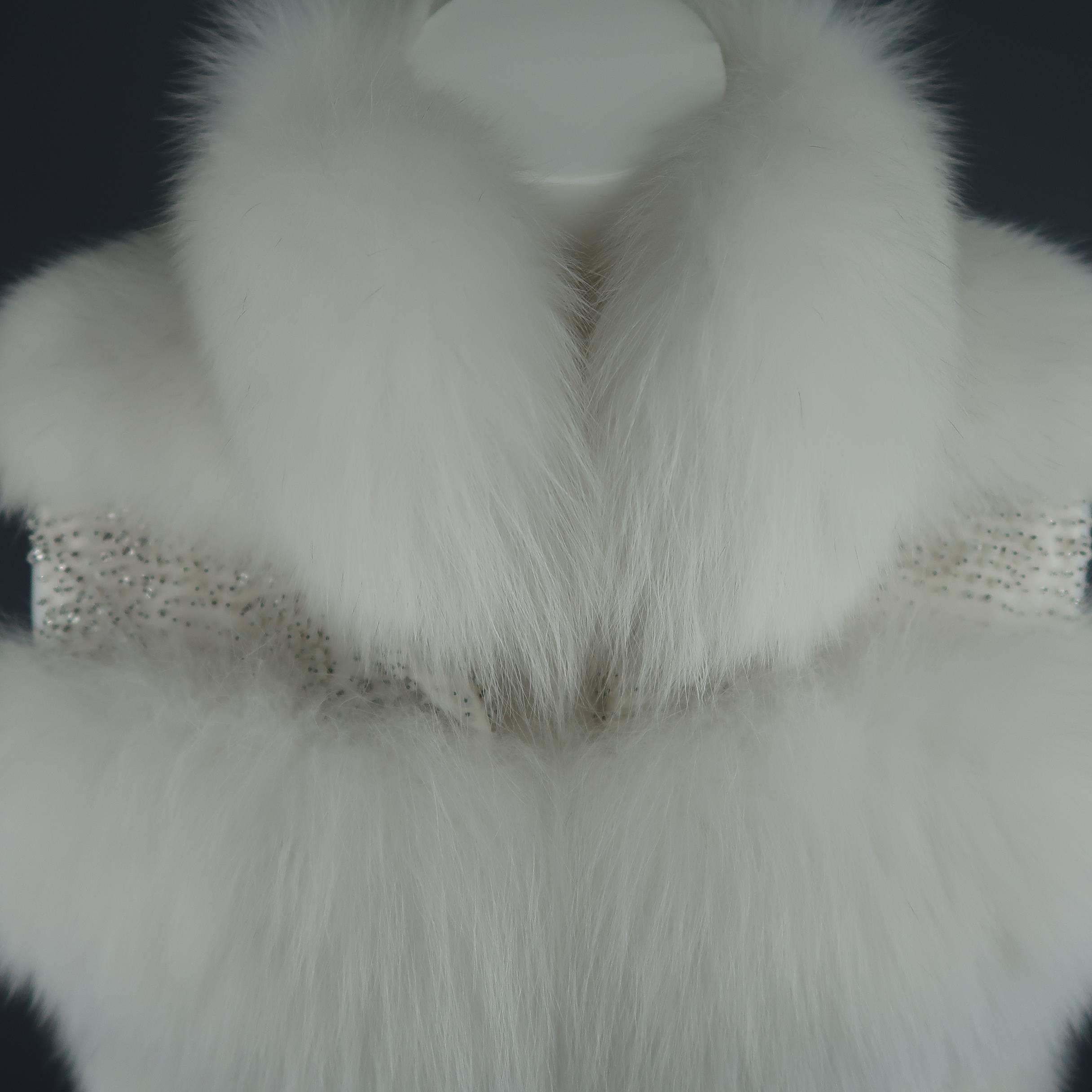 Stunning couture fox fur vest by Dennis Basso. A true show stopper, this gorgeous piece features soft snow white fur on the collar and bodice striped with panels of sparkling cream and crystal beads in between. A fabulous statement piece for an