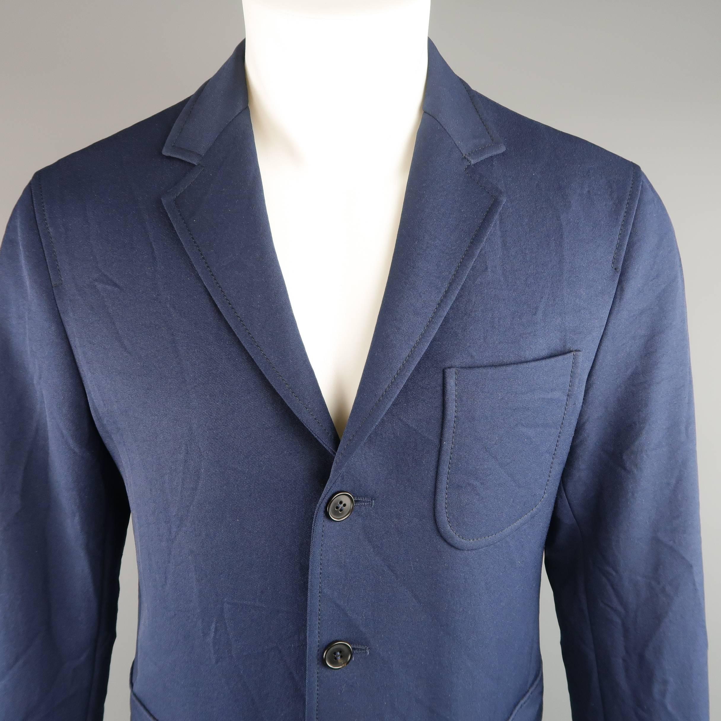 MARNI sport coat jacket comes in a wrinkle textured navy blue neoprene twill material and features a three button front, classic notch lapel, functional button cuffs, vented back and patch pockets. Made in Italy.
 
Excellent Pre-Owned