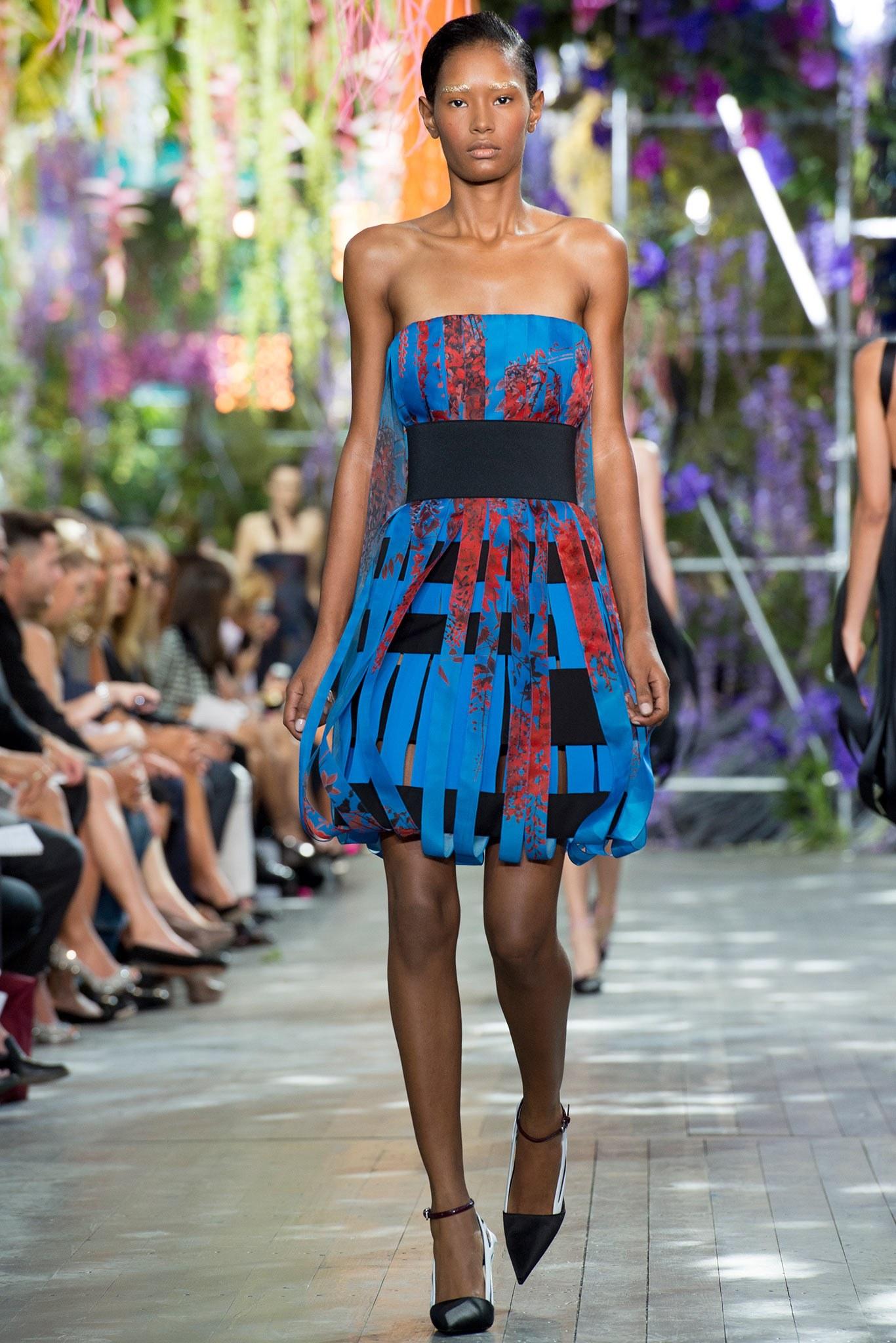 Christian Dior By Raf Simons strapless cocktail dress features a blue and black striped shift body with red floral print ribbon overlay and built in bustier. Wear it with included elastic belt or on its own. Look 37 of Spring/Summer 2014 Collection.