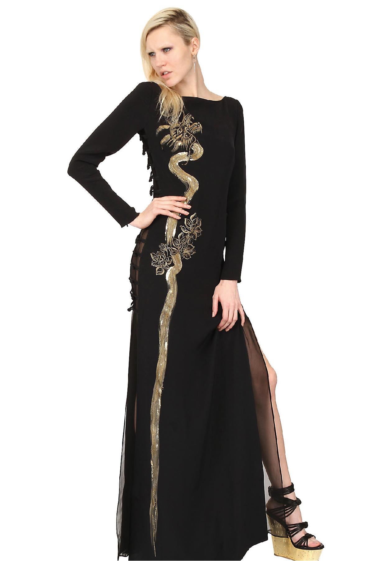 This stunning EMILIO PUCCI column gown comes in black silk crepe with a wide scoop neck, long sleeves with zip cuffs, open side cutouts with fabric buttons, chiffon liner, and beautiful hand painted metallic gold dragon motif with beading. Made in