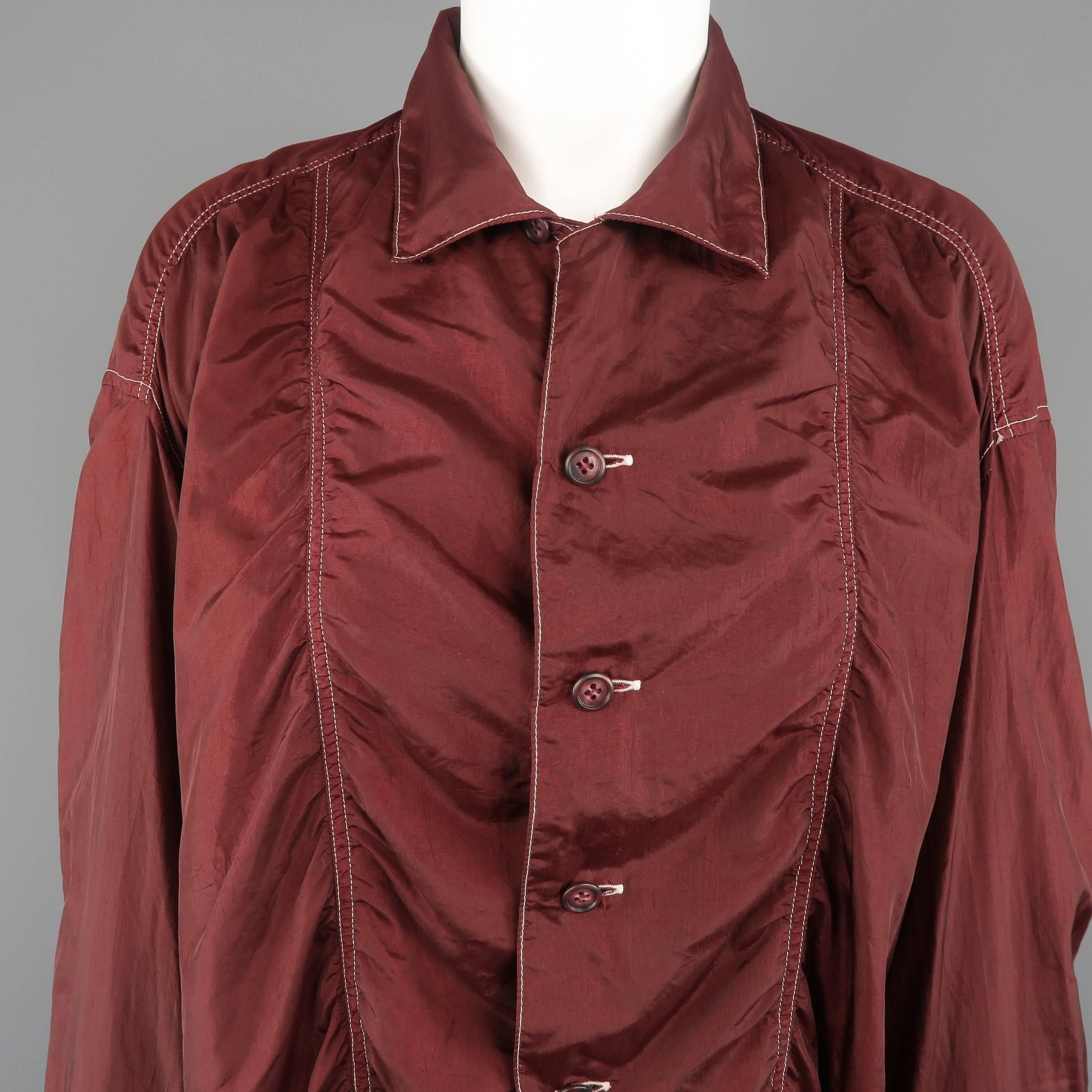 Vintage Issey Miyake oversized shirt comes in burgundy soft taffeta with contrast stitching, pointed collar, and gathered frontal seams. Wear and tags removed. As-is.
 
Good Pre-Owned Condition.
Marked: (no size)
 
Measurements:
 
Shoulder: 20