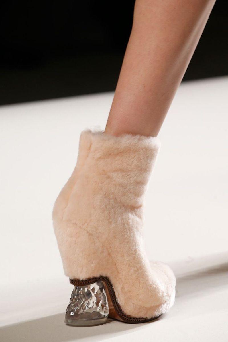 Fendi Fall / Winter 2015 runway booties come in rose pink shearling fur with a rounded point toe, covered platform, and half covered heel with clear 