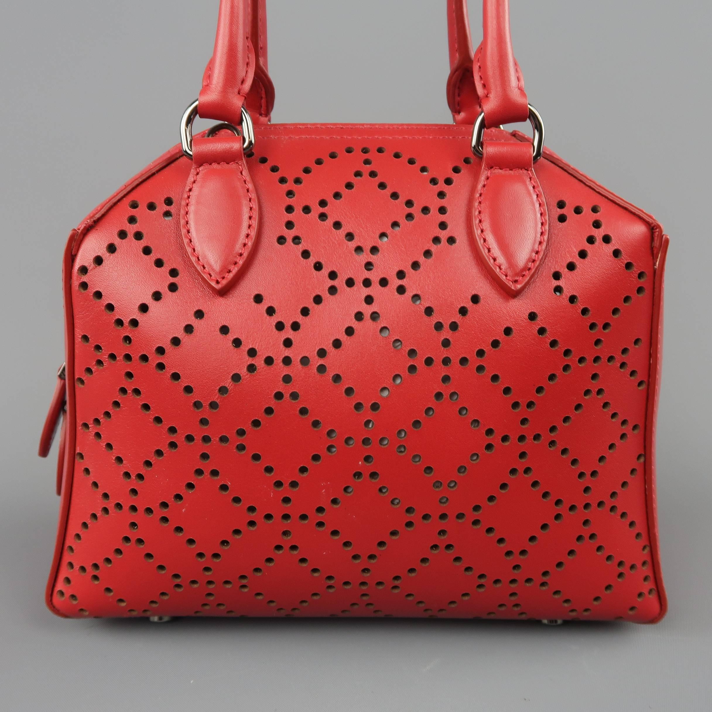 ALAIA mini bag comes in red laser cut perforated pattern leather with double covered top handles, double zip top, polished gunmetal tone hardware, internal mirror tag, and detachable crossbody strap. Made in Italy.
 
Excellent Pre-Owned Condition.
