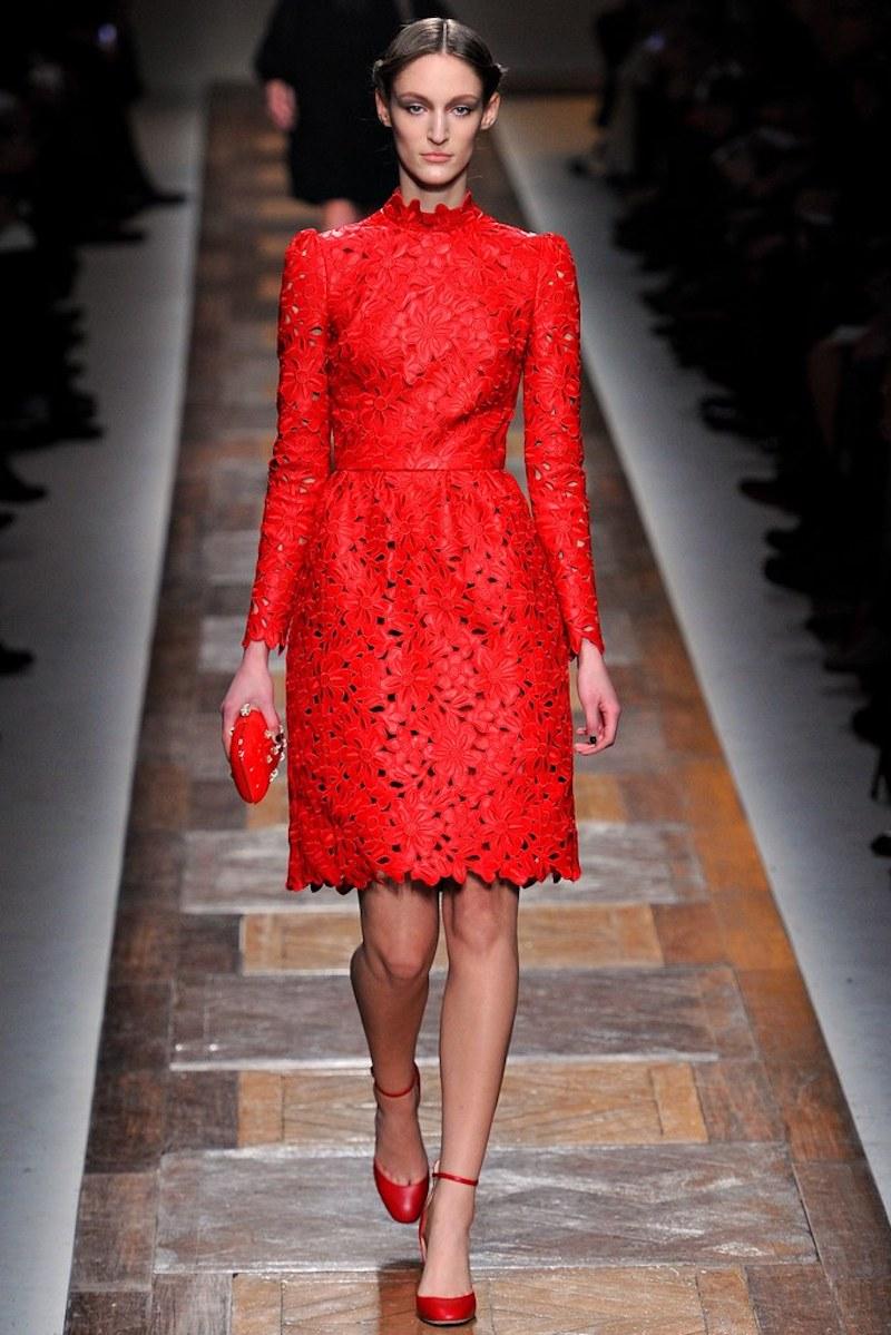 This fabulous Valentino cocktail dress circa Fall 2012 Collection design to commemorate the 50th Anniversary of the Valentino House comes in bold red, floral embroidered, laser cut leather and features a high trim neck, long puff shoulder sleeves,