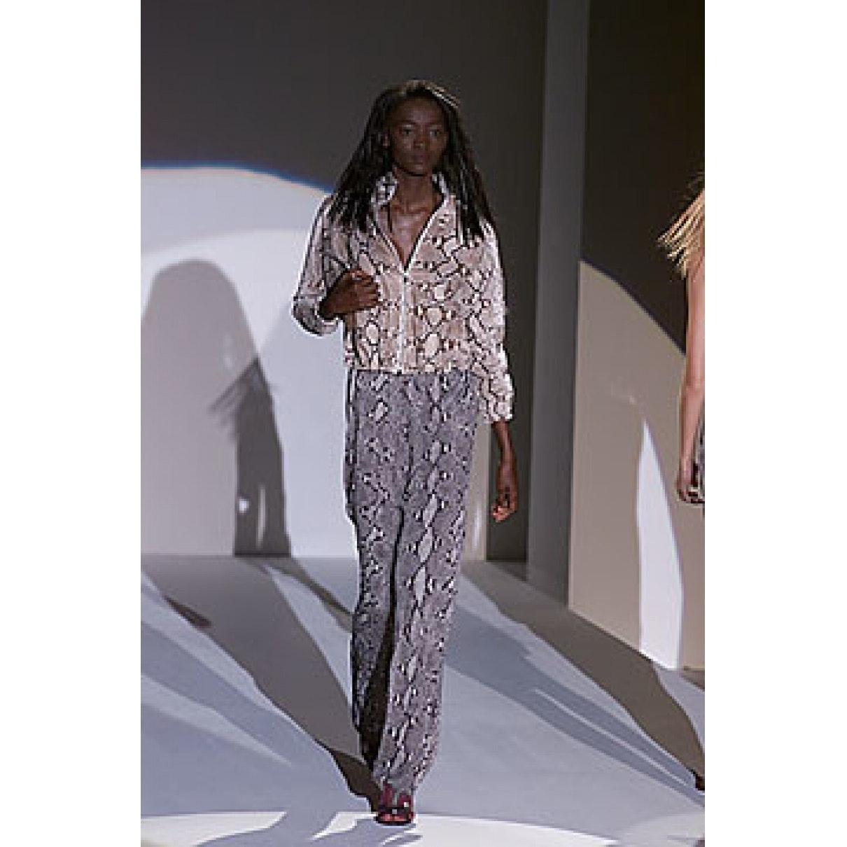 Rare GUCCI Spring 2000 Collection pants by TOM FORD come in gray python snake print rayon and feature an elastic waistband with metal belt tab, relaxed leg, darted knees, and expandable zip cuffs. Matching blouse available separately. Made in