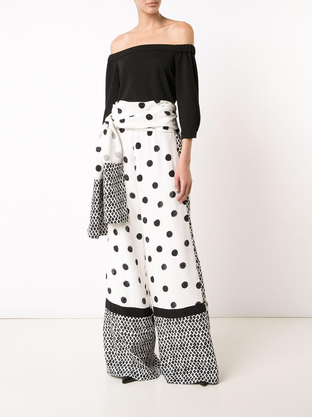OSCAR DE LA RENTA dress pants come in cream and black paint effect polka dot print silk satin with an extreme wide leg, patterned hem  and stripe panels, and side sash tie's waist detail. Circa 2017. Made in Italy.
 
Marked: 8
 
Measurements:
