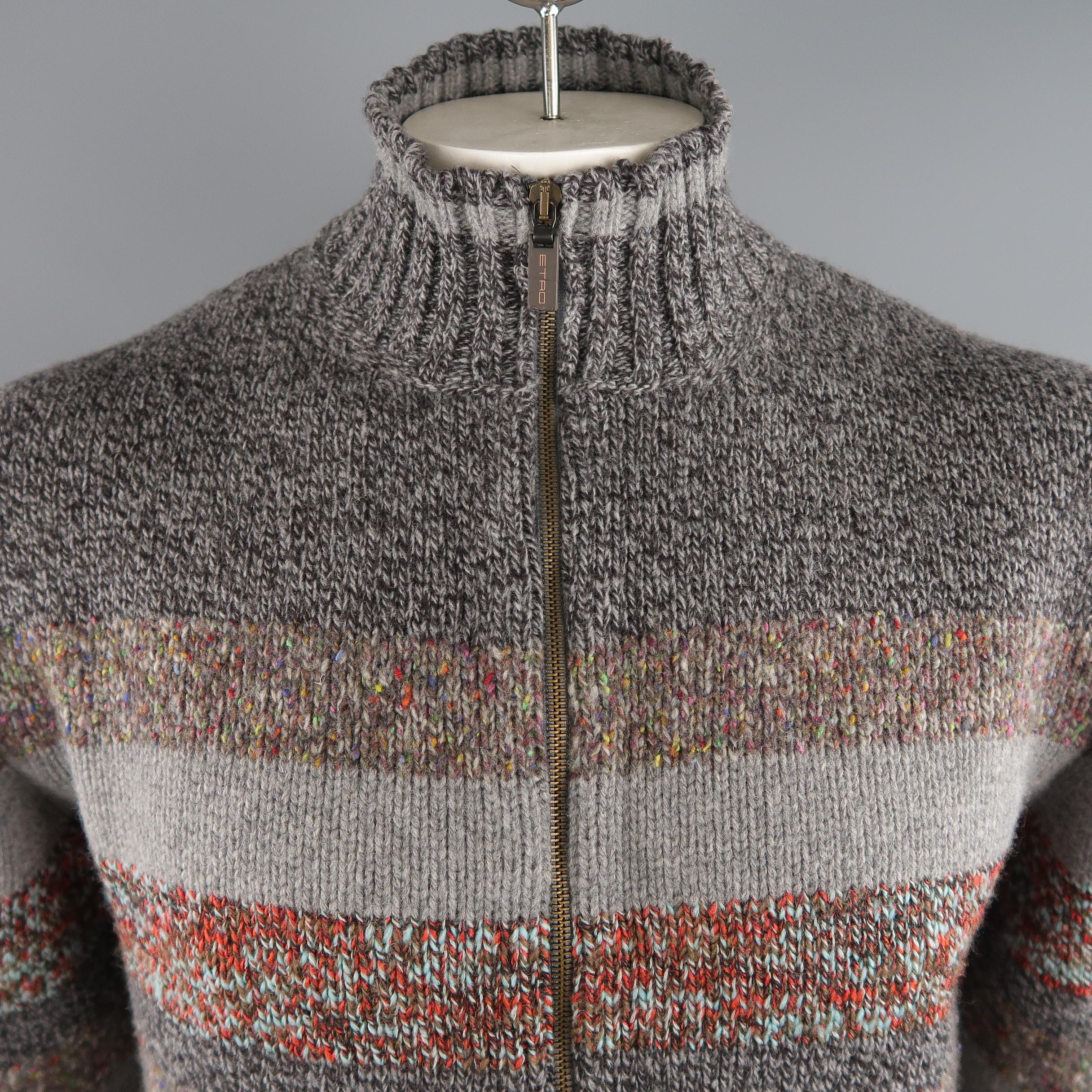 ETRO cardigan come in grey tone in knitted striped 100% wool material, with zip up front, ribbed cuffs and waistband. Made in Italy.
 
New with Tags.
Marked: XL IT
 
Measurements:
 
Shoulder: 18.5 in.
Chest: 46 in.
Sleeve: 26 in.
Length: 27 in.