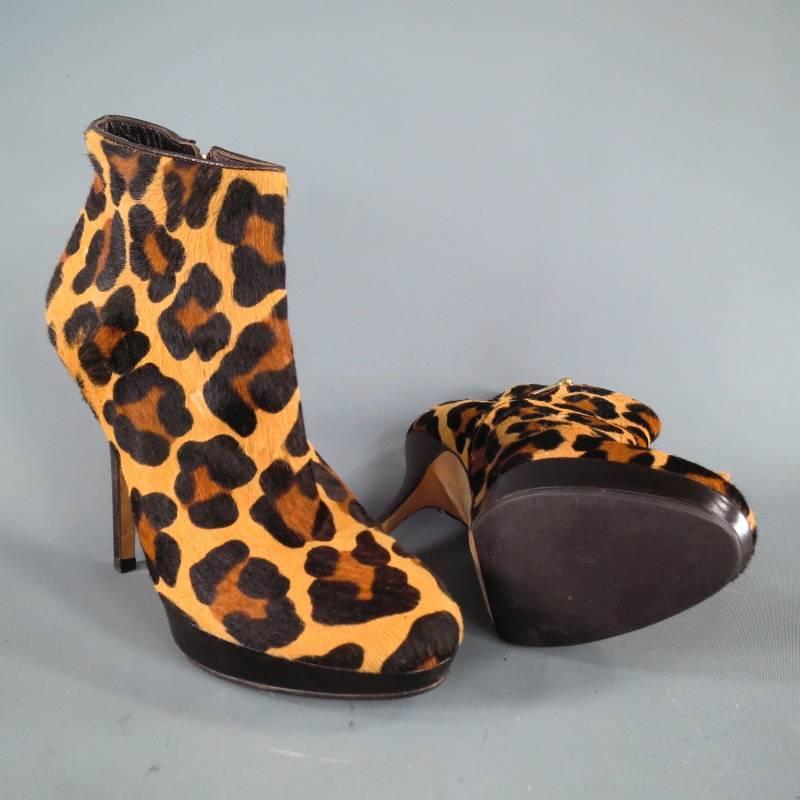 Ultra chic high heeled ankle booties by CHRISTIAN DIOR. This sleek style comes in a fabulous tan leopard print pony hair and features a round pointed toe, chocolate brown leather covered platform and stiletto heel, hidden side zip closure, and gold