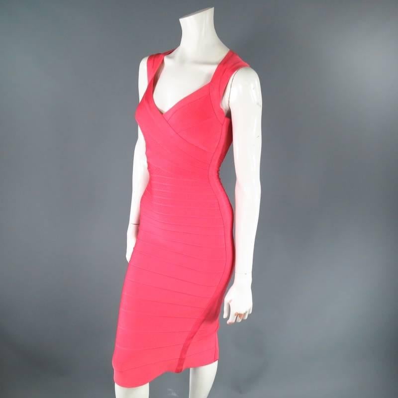 Fabulous bodycon cocktail dress by HERVE LEGER. A signature stretch bandage style midi length in lovely bold pink featuring a crossed V neckline, thick straps that fasten across the back of the neck, and gold back zipper.
 
Excellent Pre-Owned