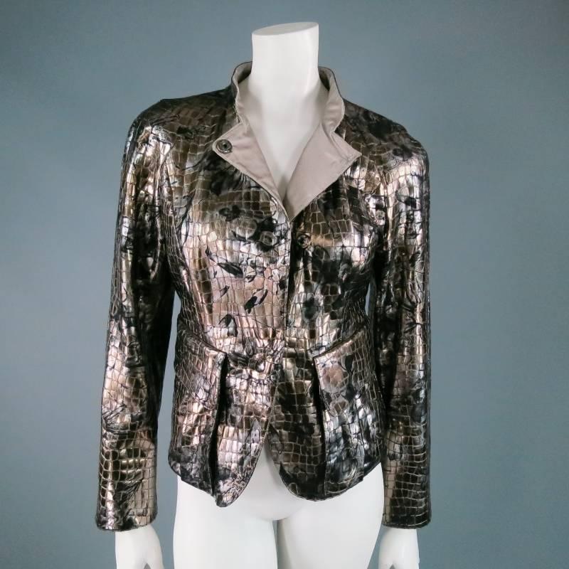 Stunning metallic motorcycle jacket by GIORGIO ARMANI. In a glossy smoke silver, alligator embossed goat leather with floral print, featuring a band collar, round shoulder, and slight peplum silhouette, and pleated patch pockets. A versatile, light