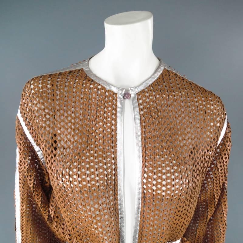 Rare and fabulous mesh robe coat by MISSONI. This unique style comes in an interlock woven mesh made of tan leather and features a two button closure, under arm vents, and metallic silver leather piping and waist belt. Made in Italy.
 
Excellent