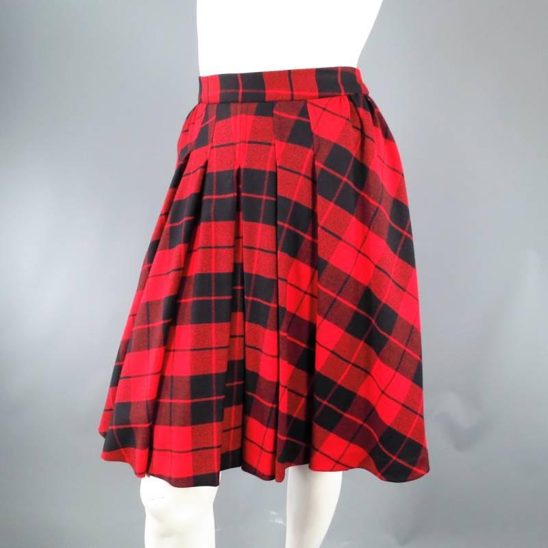 Fabulous red and black plaid skirt by D&G. This fun and flattering style comes in a classic tartan plaid and features an A-line silhouette, pleated and gathered front, box pleated back with exposed zipper, and layered crinoline petticoat lining.