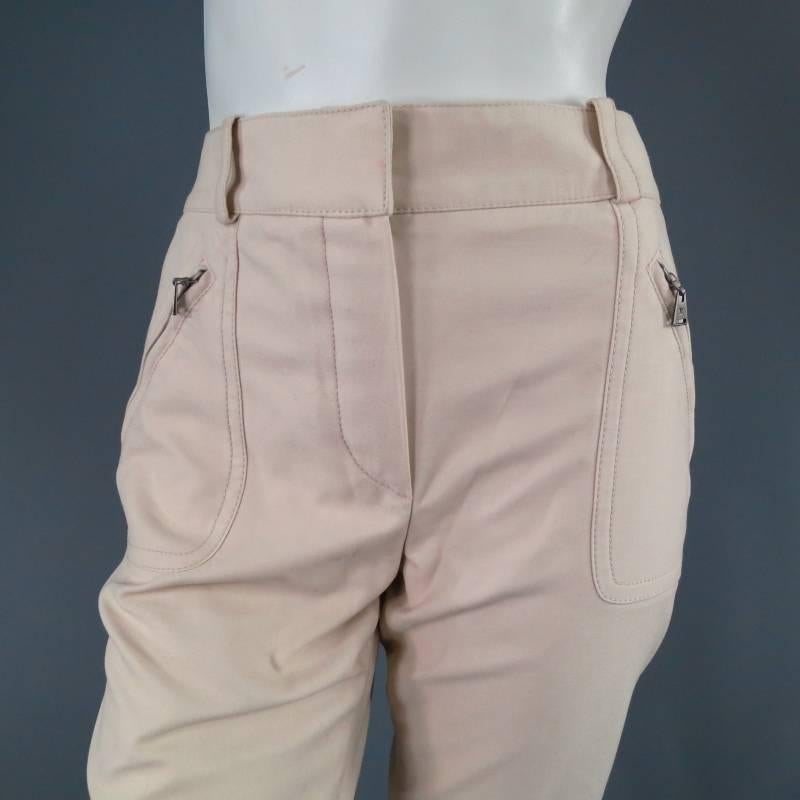Ultra chic khaki dress pants by LOUIS VUITTON. A sleek ready to wear riding pant style with decorative seams and slit zip pockets. This piece comes unworn with tags attached with one minor discoloration on front of waistband shown in detail shots.