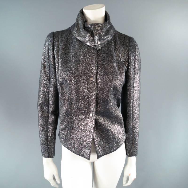 Fabulous metallic jacket by ESCADA SPORT. This unique piece comes in a charcoal structured fabric covered in shiny silver spotted print and features slit pockets, silver hardware snap closure, full organza lining, and detachable fold over snap