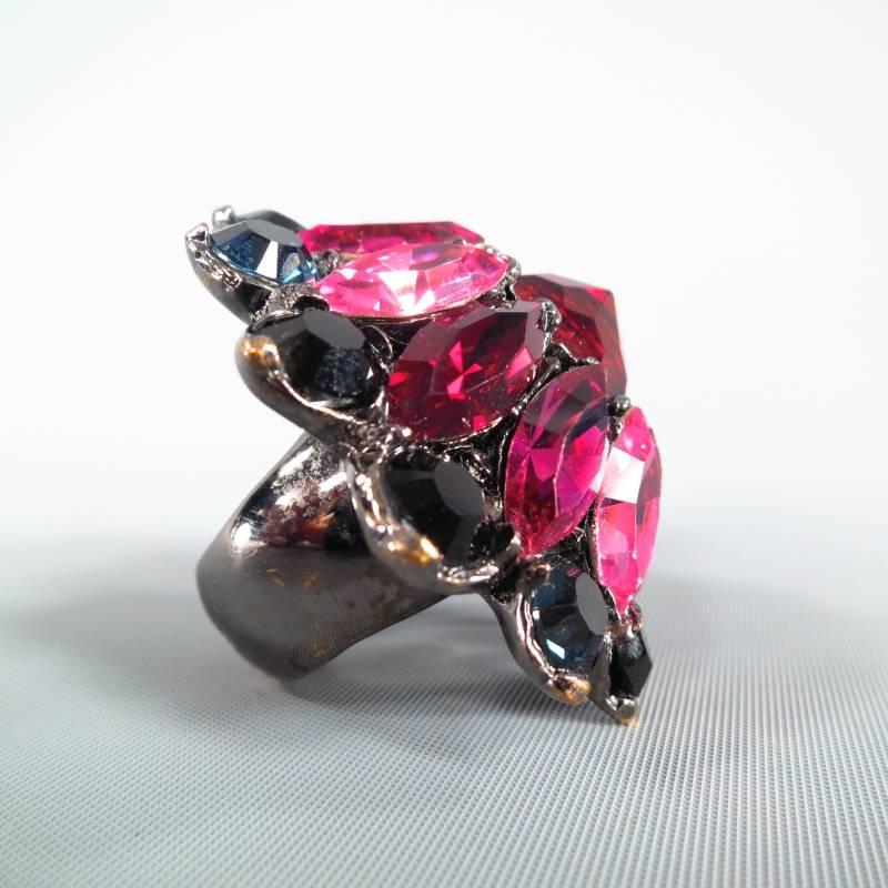 Gorgeous jeweled cocktail ring by YVES SAINT LAURENT. This rare and unique style comes in a round floral shape and features a round ruby red crystal center surrounded by fuschia, pink, and red marquise crystals with an outer border of navy circular