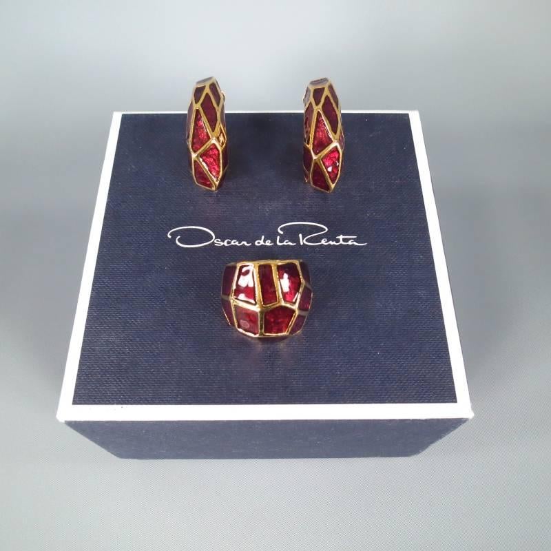 Gorgeous earring set by OSCAR DE LA RENTA. This classic chic set includes a pair of structural, gold tone, giraffe print, clip on hoop earrings with ruby red metallic enamel details and a matching cocktail ring. This set includes original box and is