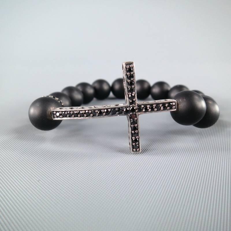 Lovely beaded bracelet by TAI. A chic black wooden sphere beaded style featuring a black crystal covered bead and a silver tone cross with black crystals and heart cutouts.
 
Excellent Pre-Owned Condition.
 
Length: 8 in.
 